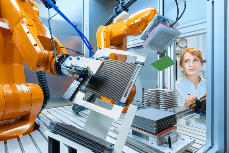 women watches SOEC stack assembling robot